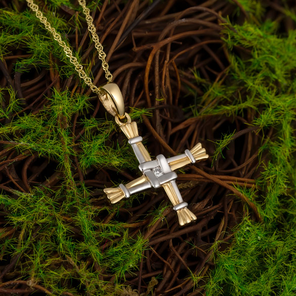 Styled image of two tone gold St Brigids cross necklace